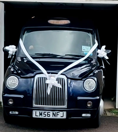 Taxi with a white ribbon